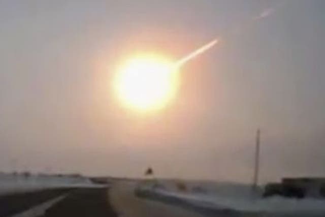 A meteor trail is seen in this frame grab made from a dashboard camera on a highway in Kazakhstan