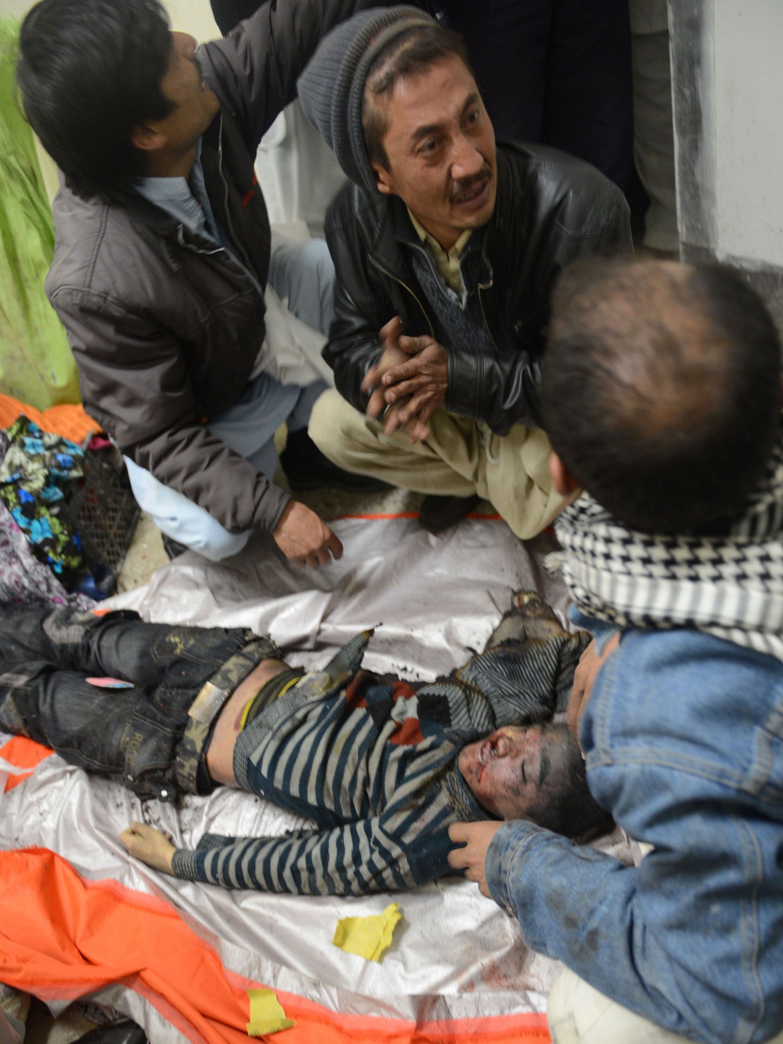 Relatives with the body of a child caught in the blast