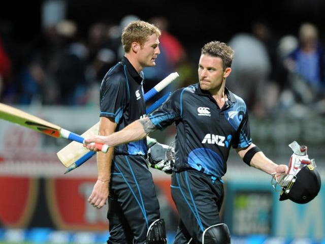 New Zealand's Brendon McCullum, right, salutes the crowd as he walks off with Martin Guptill after defeating England by three wickets
