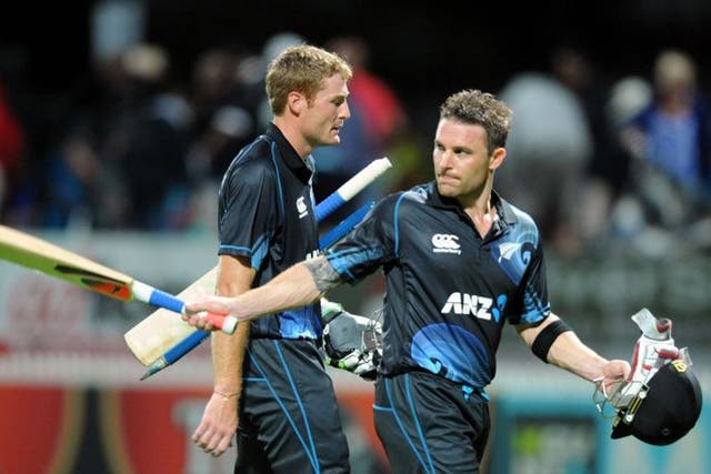 New Zealand's Brendon McCullum, right, salutes the crowd as he walks off with Martin Guptill after defeating England by three wickets