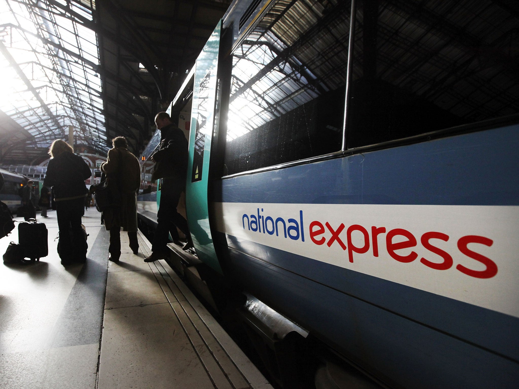 Members of the public disembark a National Express train