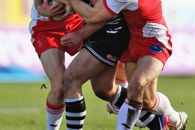 Stefan Marsh, of Widnes, is tackled by Hull KR’s Michael Dobson and Kris Welham