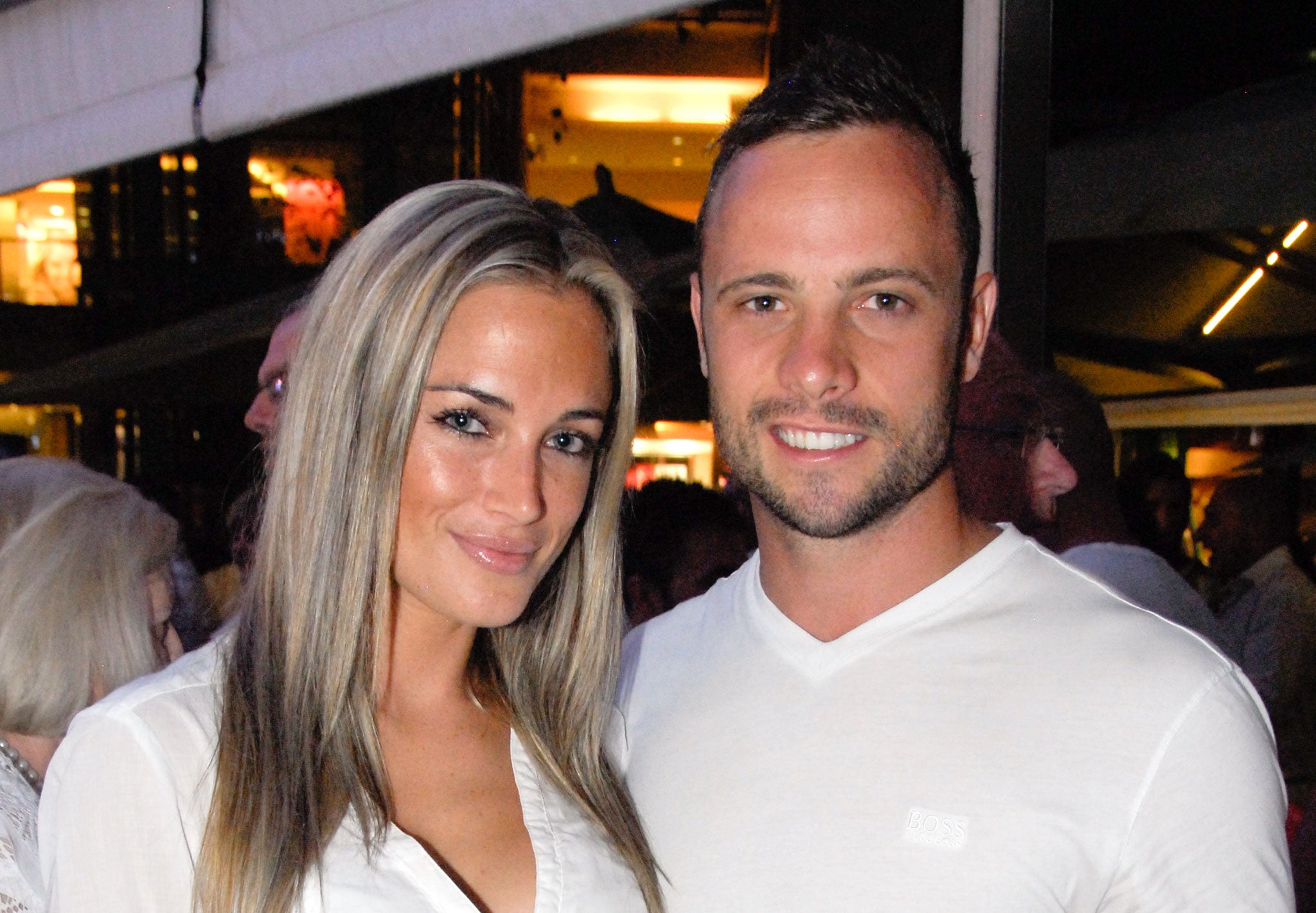 South African model Reeva Steenkamp (left), with her former boyfriend Oscar Pistorius, who stands accused of her murder
