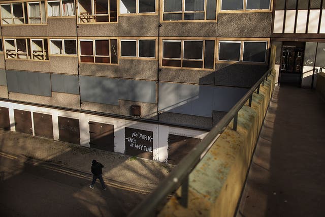 A man walks in late afternoon sunshine on the Heygate housing estate near Elephant and Castle on February 11, 2010 in London, England. 