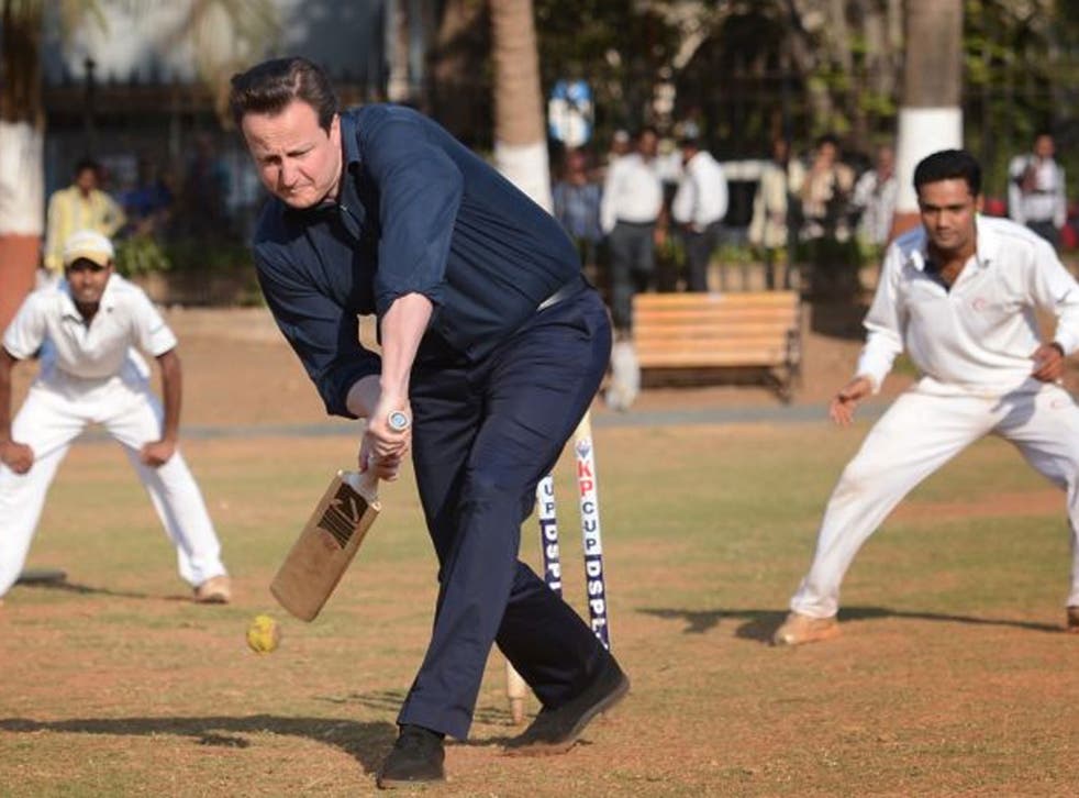 Prime Minister David Cameron plays cricket with Indian boys at the Oval Maidan, a communal cricket pitch in the centre of Mumbai, India