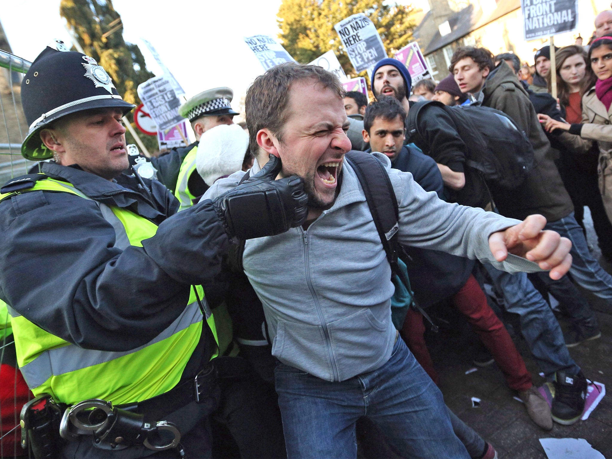 A protester clashes with police outside Cambridge University’s Student Union yesterday