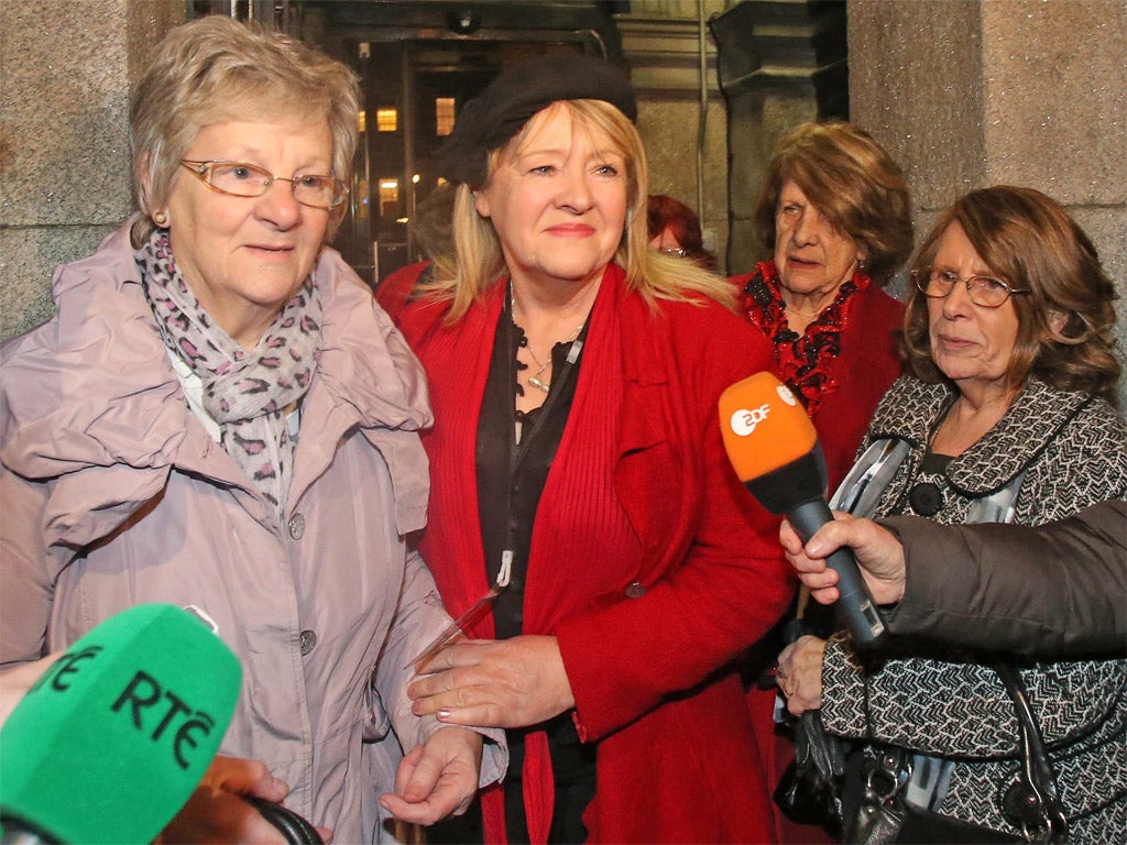 Marina Gambold (left) and Maureen Sullivan (centre) of Madalene Survivors Together leaving Leinster House in Dublin after hearing Taoiseach Enda Kenny's state apology