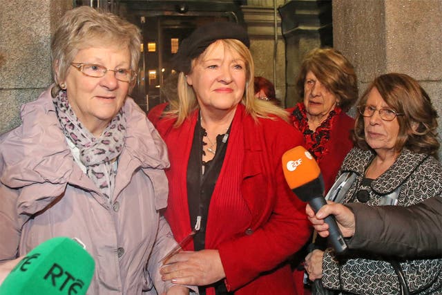 Marina Gambold (left) and Maureen Sullivan (centre) of Madalene Survivors Together leaving Leinster House in Dublin after hearing Taoiseach Enda Kenny's state apology 
