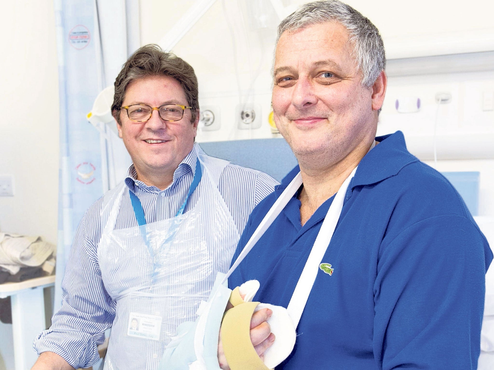Professor Simon Kay, far left, with his patient, Mark Cahill, the first person in the UK to have a hand transplant