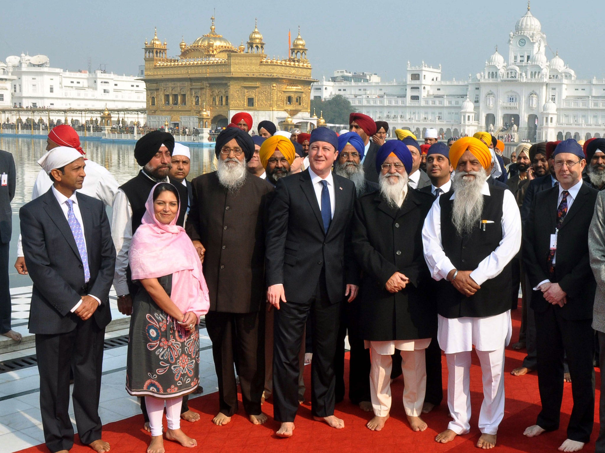 Britain's Prime Minister David Cameron poses inside the premises of the holy Sikh shrine the Golden temple in the northern Indian city of Amritsar