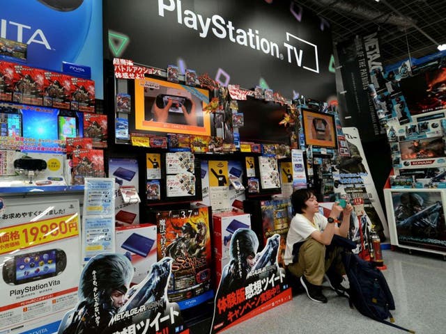 A Japanese video game fan in a Tokyo electrics shop as Sony prepares to reveal its vision of the future of home entertainment by providing a glimpse of a new-generation PlayStation console that streams games, films, music and more