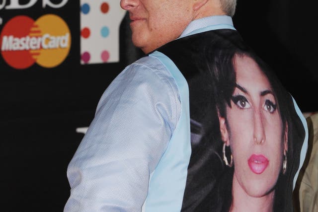 Mitch Winehouse wears a tribute to late daughter, Amy Winehouse, at the Brit Awards 2013