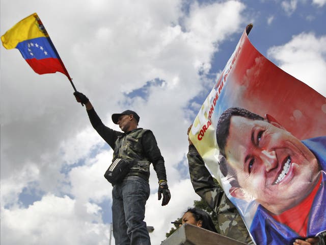 A supporter of Venezuela's President Hugo Chavez waves the national flag in front of the military hospital where Chavez is being treated, in Caracas