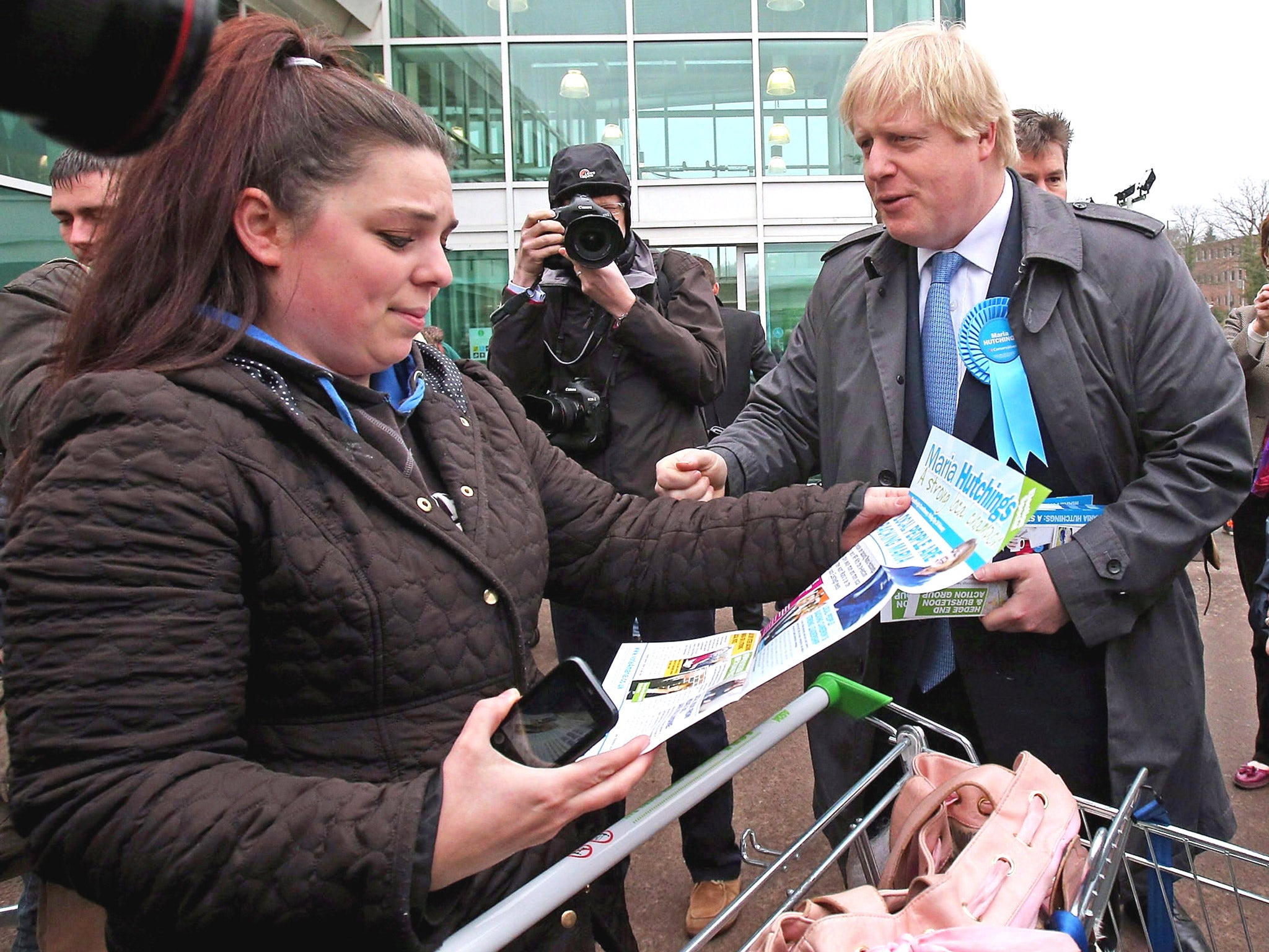 Boris Johnson speaks to a shopper in Eastleigh in support of Conservative candidate Maria Hutchings