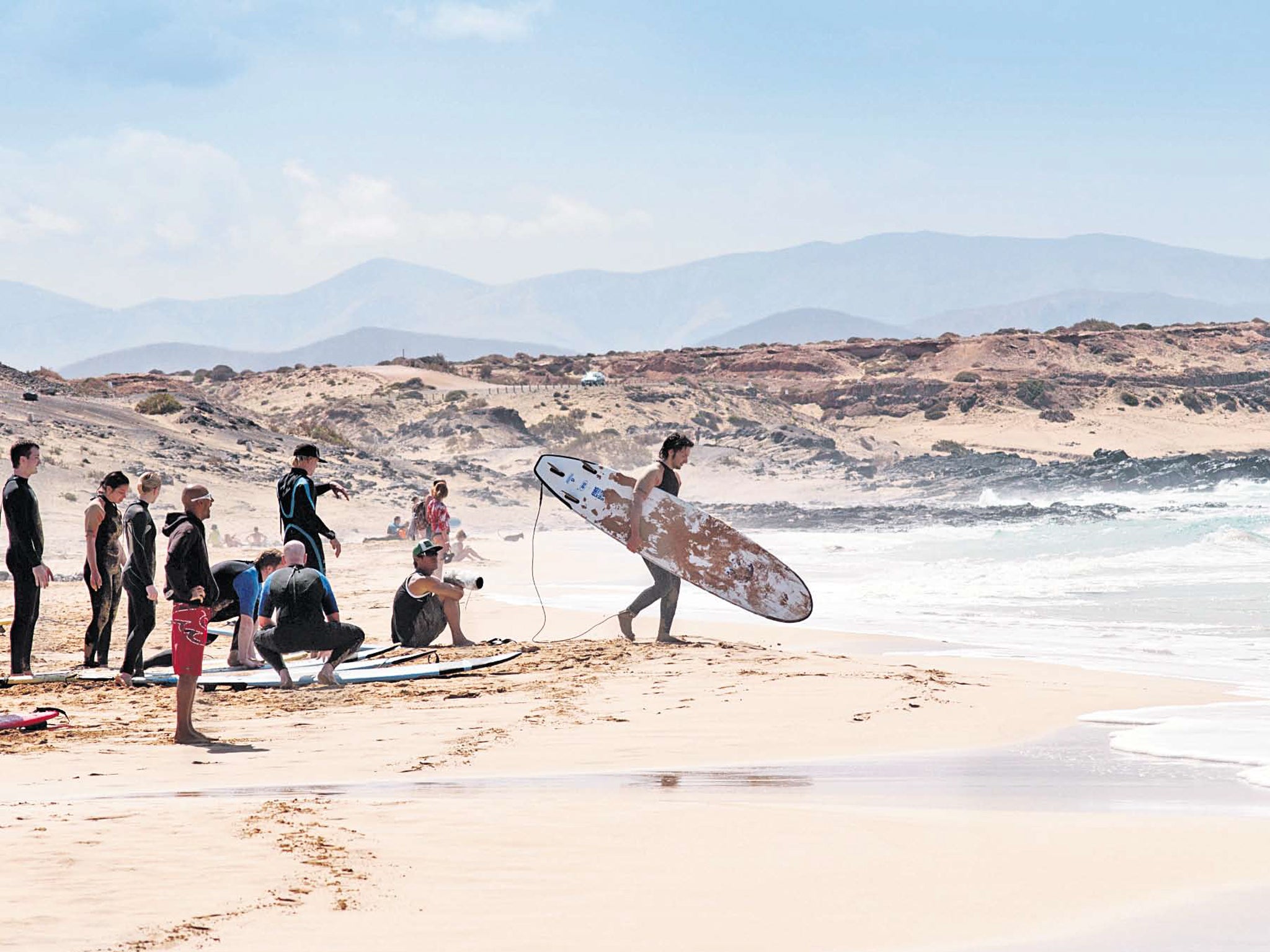 All aboard: surfers prepare to ride the waves at Playa Cotillo
