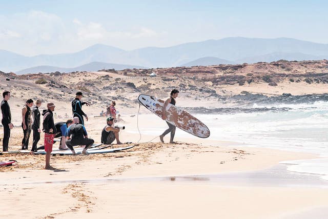 All aboard: surfers prepare to ride the waves at Playa Cotillo