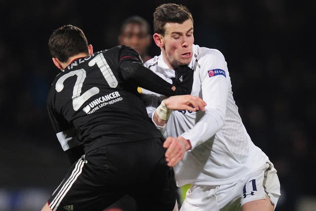 Spurs’ Gareth Bale is blocked by Maxime Gonalons