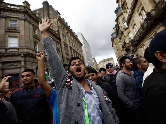 Protestors gesture against members of the English Defence League during a demonstration on August 27, 2010 in Bradford