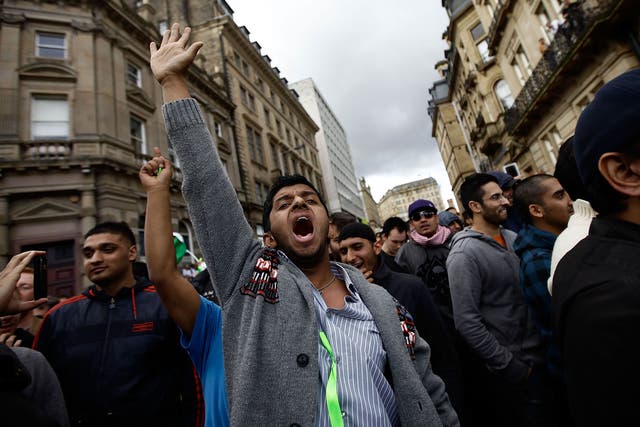 Protestors gesture against members of the English Defence League during a demonstration on August 27, 2010 in Bradford