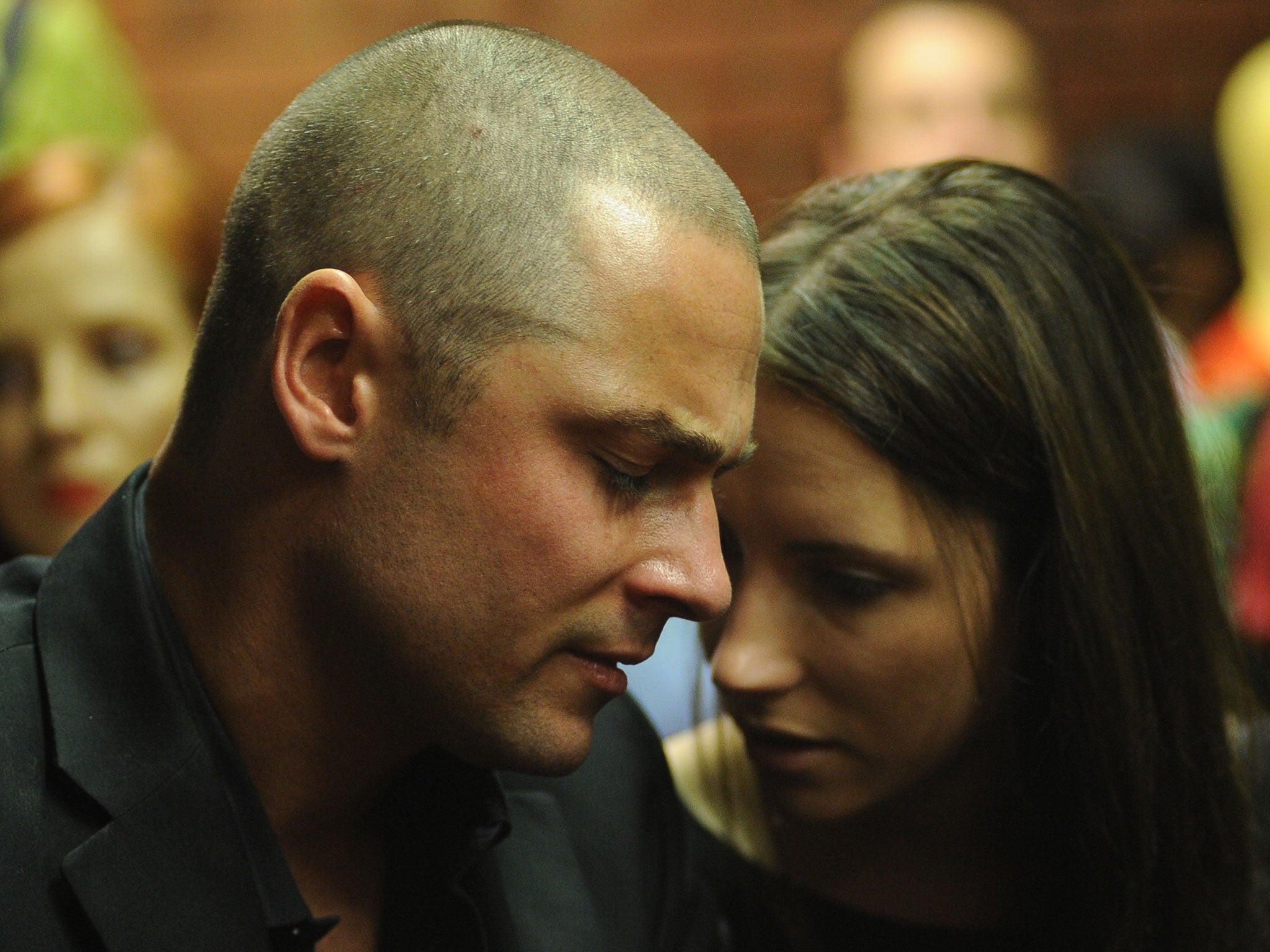 Oscar Pistorius's brother Carl (L) and sister Aimee wait on February 22, 2013 at the Magistrate Court in Pretoria.