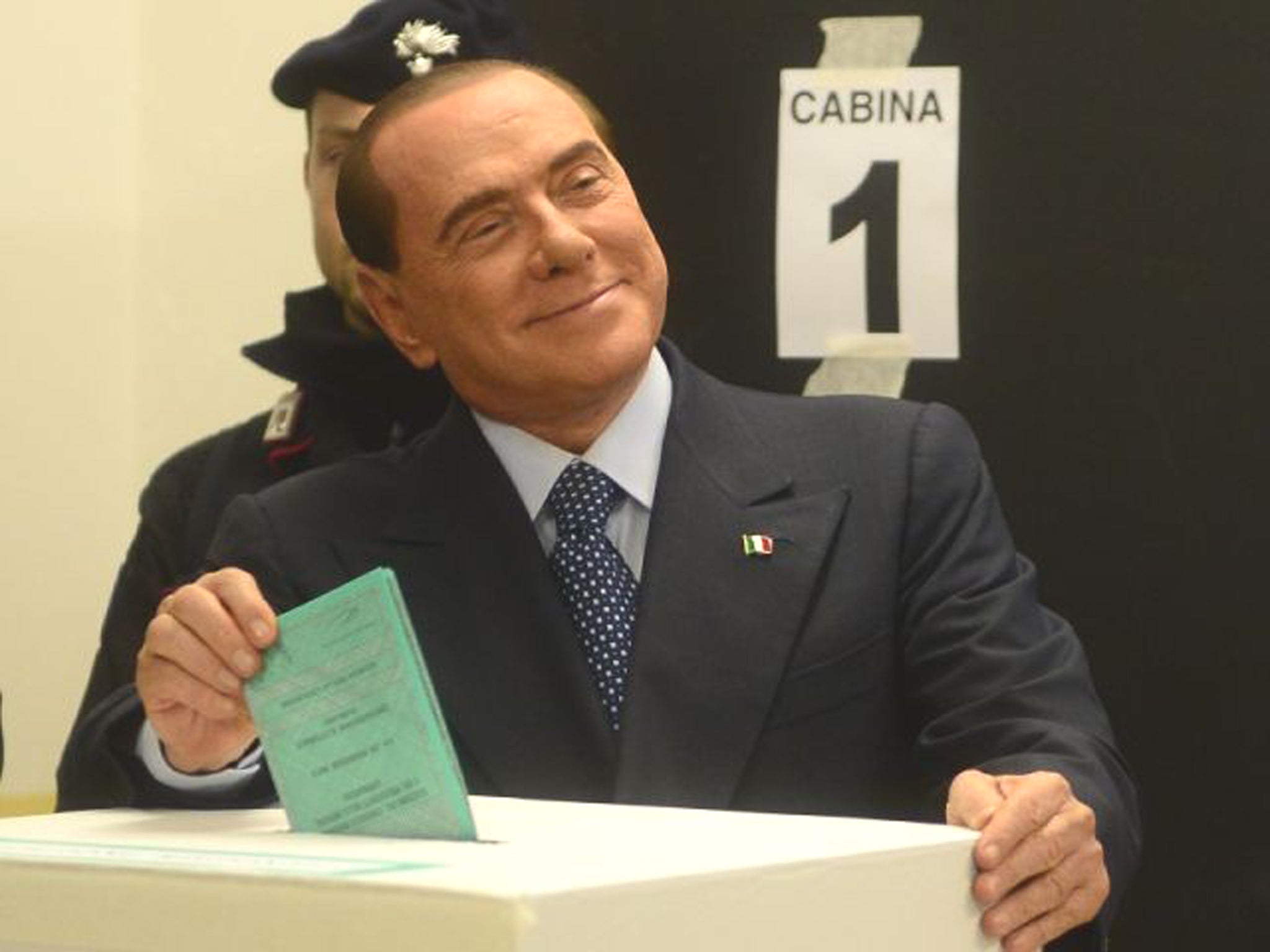 Italian former Prime Minister Silvio Berlusconi casts his ballot at a polling station 