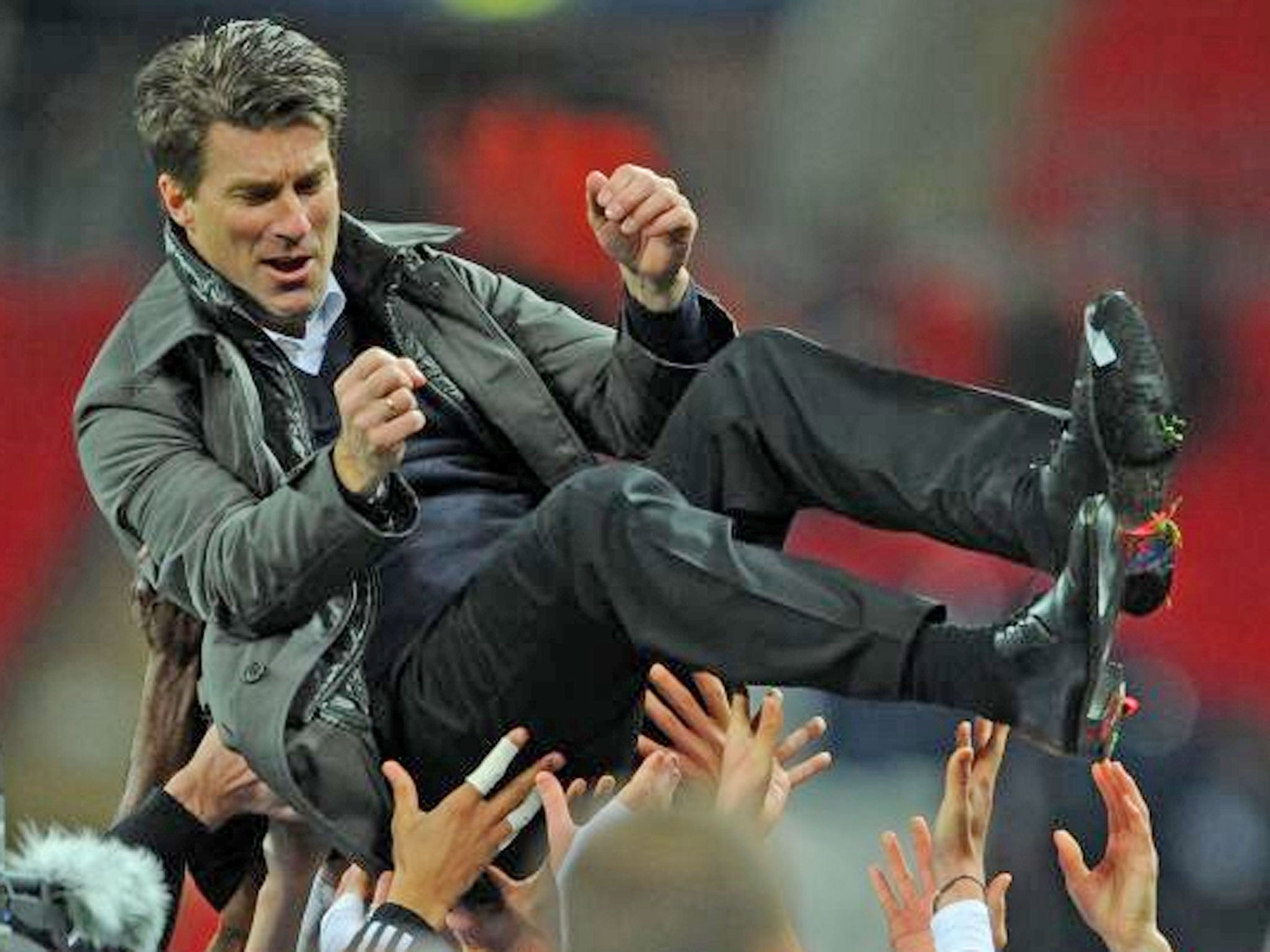 Michael Laudrup celebrates winning the trophy yesterday