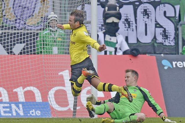 Dortmund’s Mario Götze is fouled by goalkeeper Marc-Andre
ter Stegen to earn his side a penalty – which he then converted