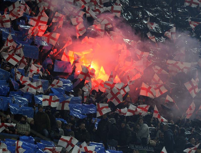 Inter fans wave flags and set off flares at the San Siro