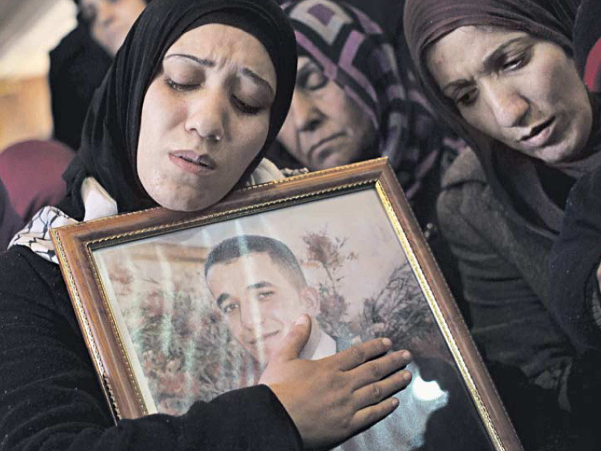 Palestinian women mourn at the funeral of Arafat Jaradat in the
West Bank town of Si’ir, near Hebron