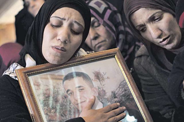 Palestinian women mourn at the funeral of Arafat Jaradat in the
West Bank town of Si’ir, near Hebron