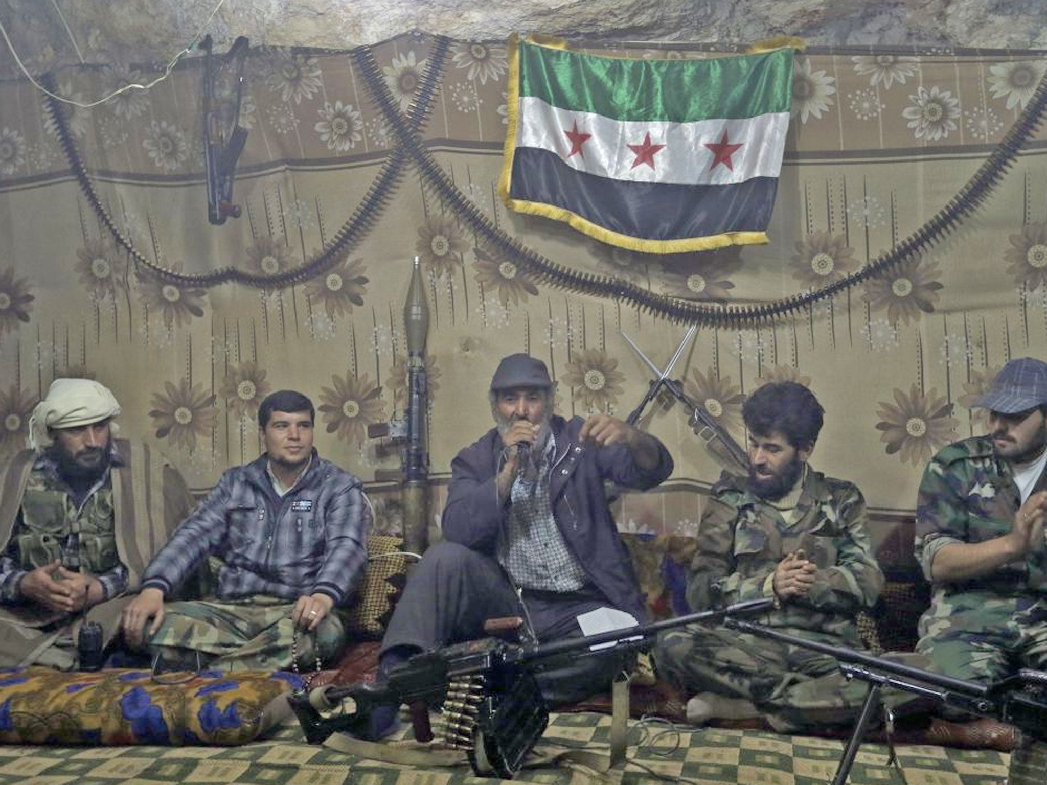 Free Syrian Army fighters gather at one of their caves in Jabal al-Zaweya, Syria, whom reject talks until President Bashar Assad leaves