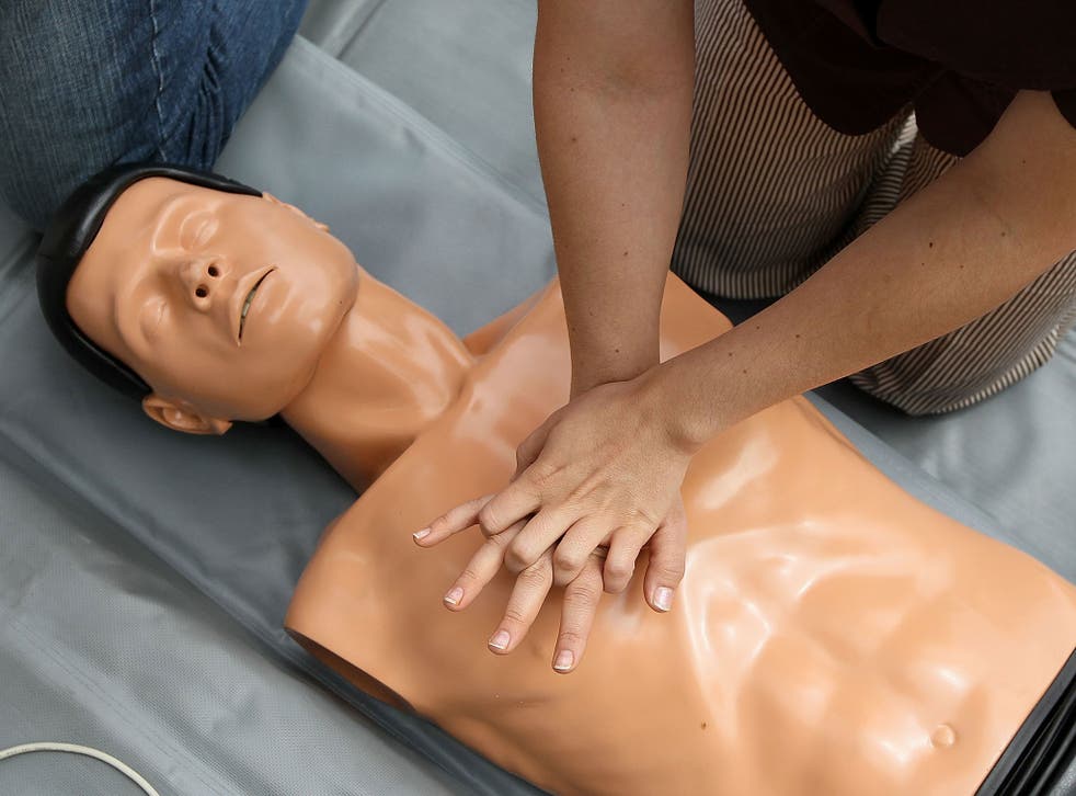 A woman performs chest compressions on a mannequin while learning C.P.R. on the steps of San Francisco city hall following a press conference celebrating the 50th anniversary of lifesaving by using C.P.R. June 1, 2010 in San Francisco, California.