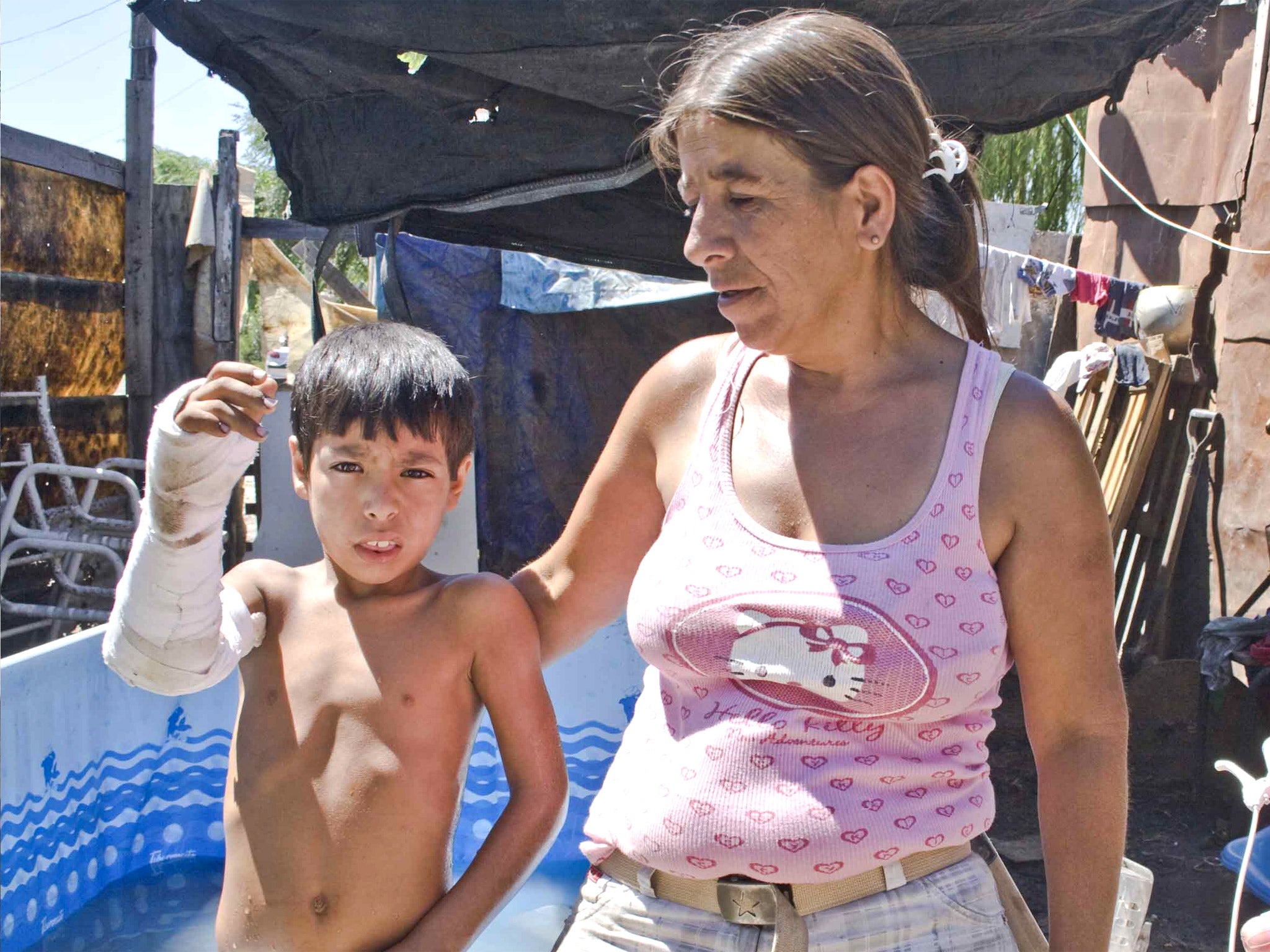 Leonardo Perera with his mother Silvia. The bullet that hit Leonardo entered his right arm and exited though his right leg as he was sleeping