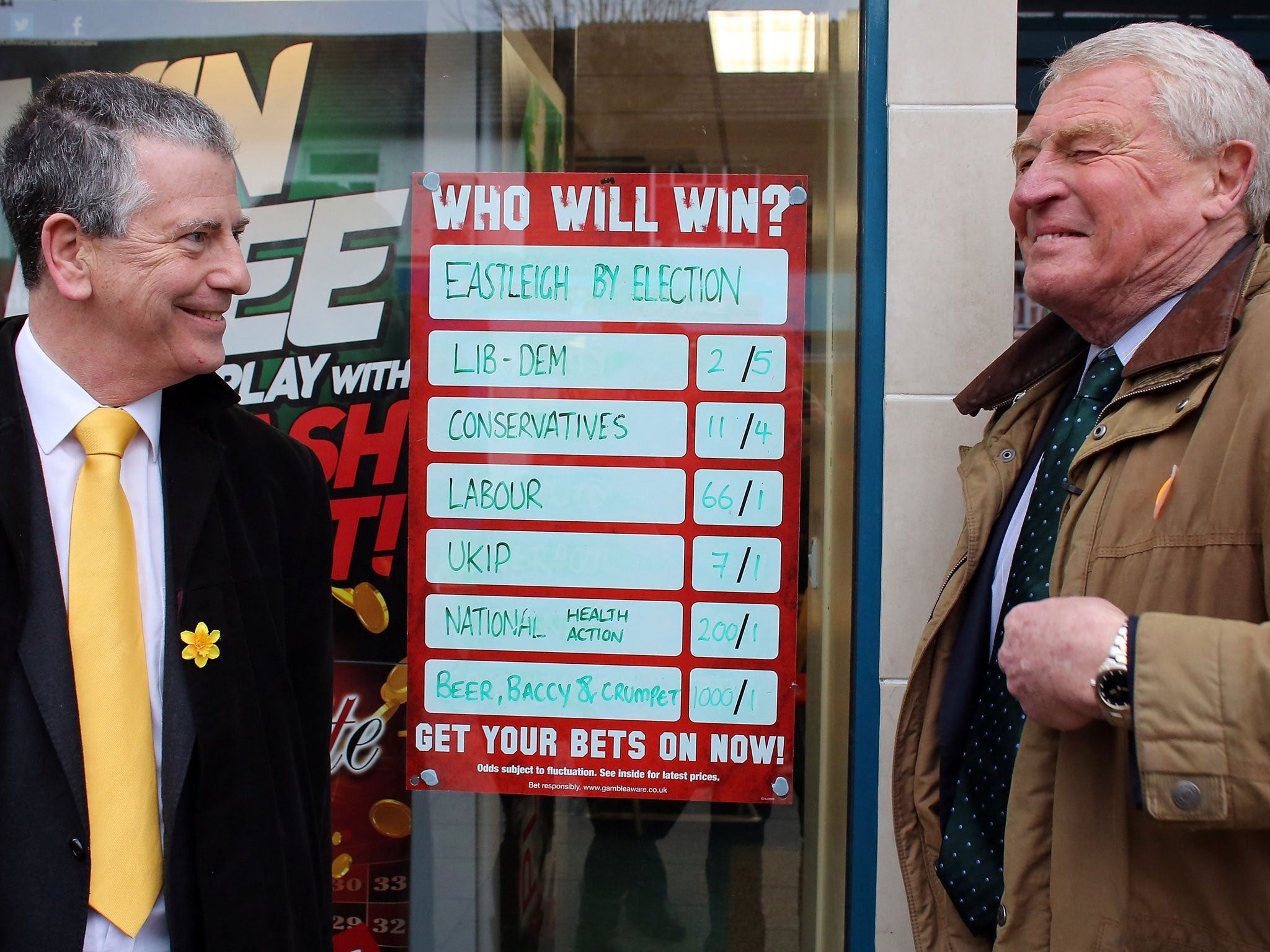 Former Liberal Democrat leader Lord Paddy Ashdown (R) stands beside a bookmakers' odds for the election as he campaigns with Liberal Democrat candidate Mike Thornton (L) for the forthcoming by-election on February 26, 2013 in Eastleigh, England.