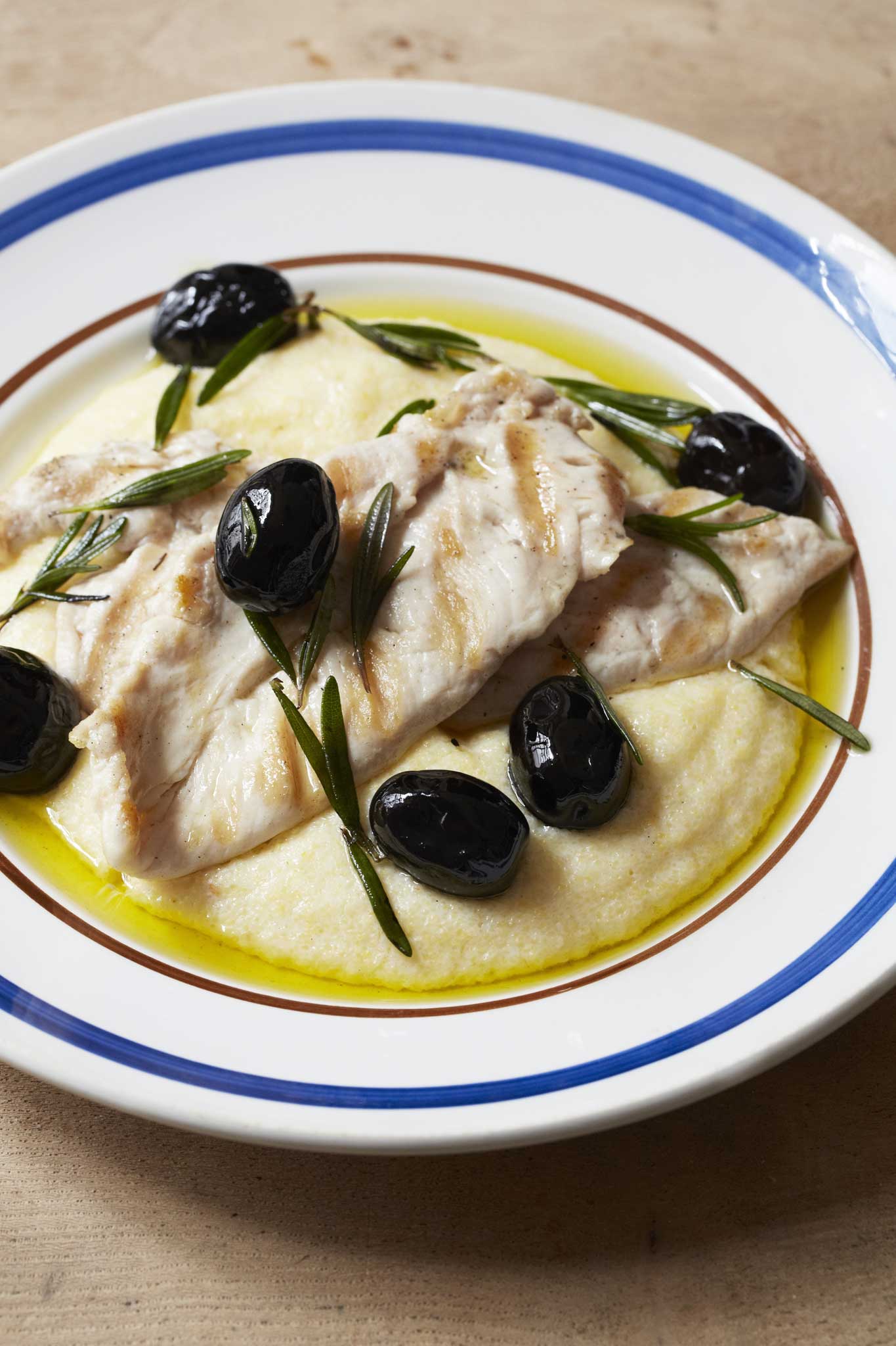 Chicken piccatas with polenta, black olives and rosemary