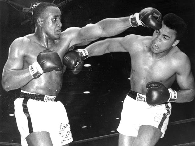 Cassius Clay (later known as Muhammad Ali) lands a right on the body of Sonny Liston in 1964