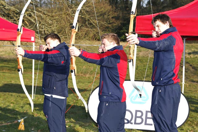 England’s Ben Youngs, Tom Youngs and Tom Wood (from left) try their hand at archery at Pennyhill Park yesterday