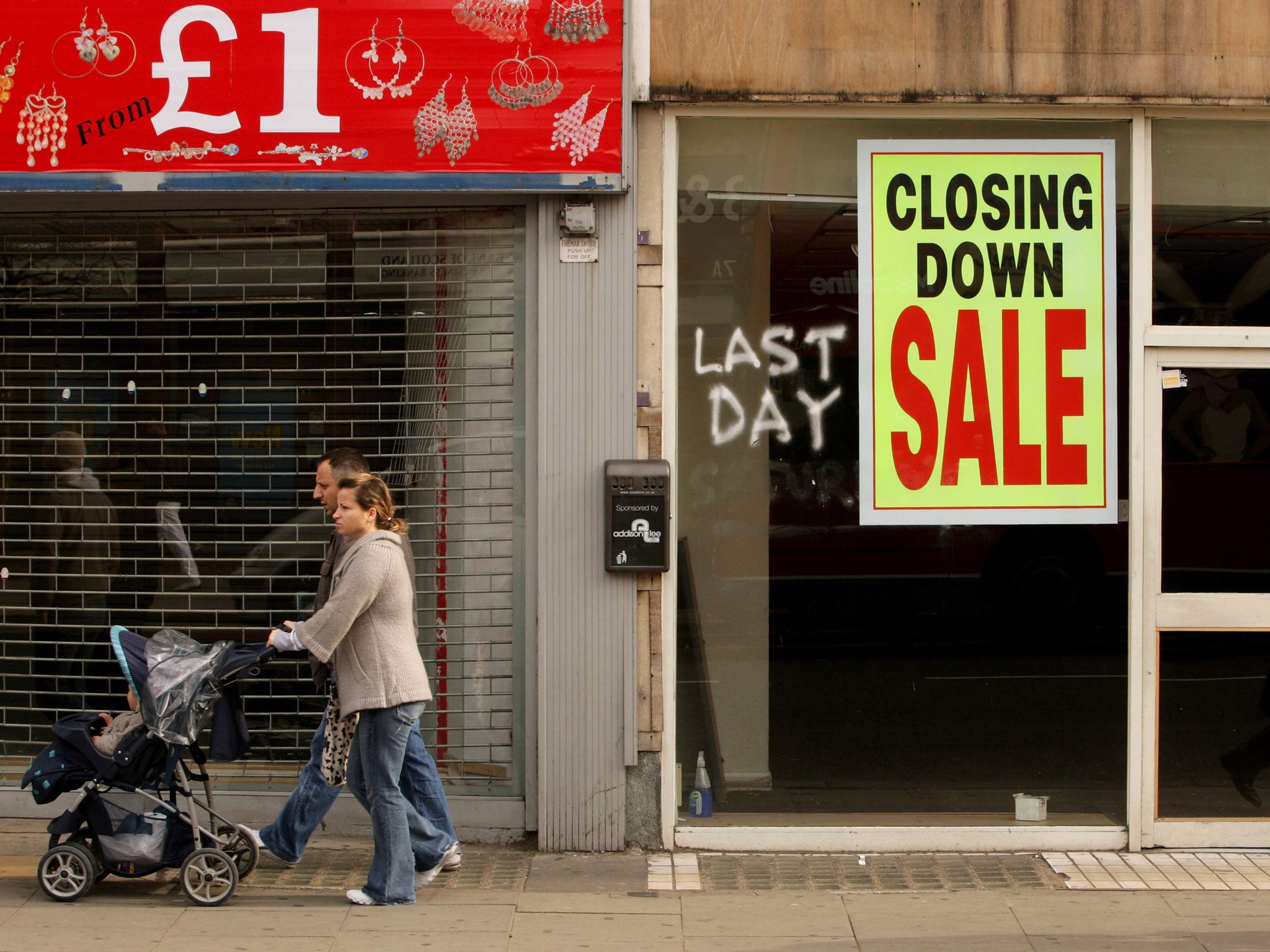 Members of the public walk past shops on Kilburn High Road on March 13, 2009 in London, England. The UK recession is seeing an increasing number of high street store closures, with many well established brands unable to survive the downturn.