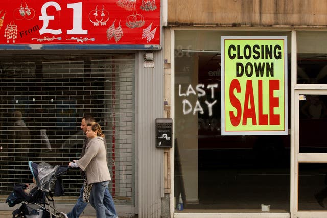 Members of the public walk past shops on Kilburn High Road on March 13, 2009 in London, England. The UK recession is seeing an increasing number of high street store closures, with many well established brands unable to survive the downturn.