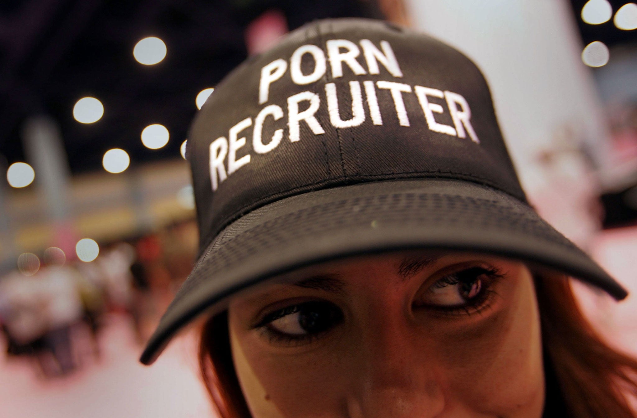 A 'Porn Recruiter' wears her hat during the EXXXOTICA convention in Miami Beach