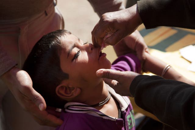 A child is given two drops of a vaccine in Delhi
