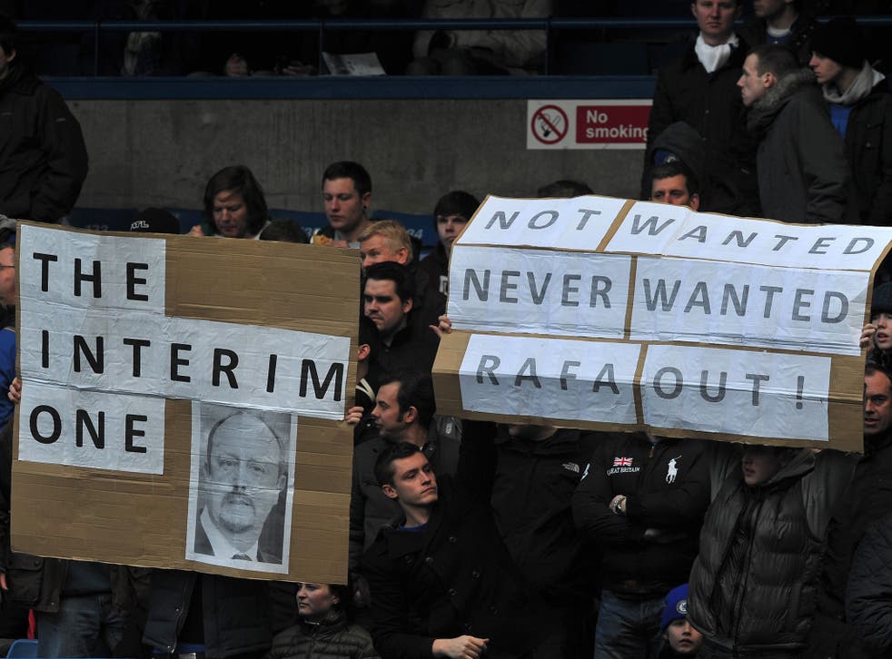 Chelsea fans hold placards showing their discontent with Interim manager Rafa Benitez