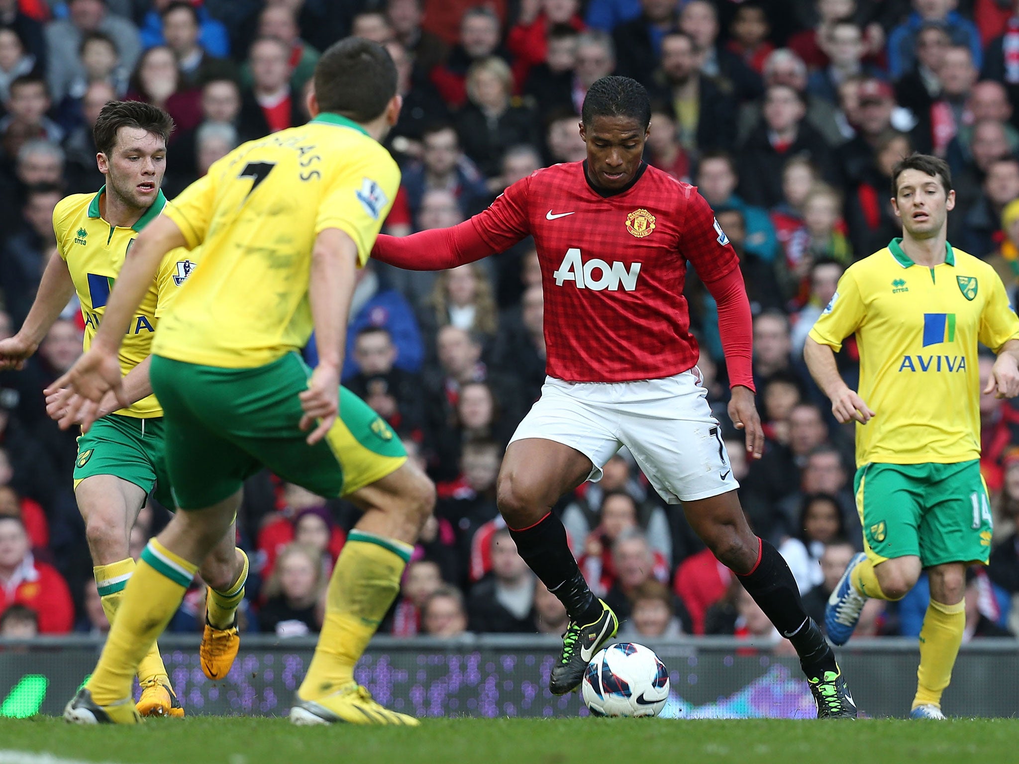 Antonio Valencia of Manchester United in action with Robert Snodgrass of Norwich City