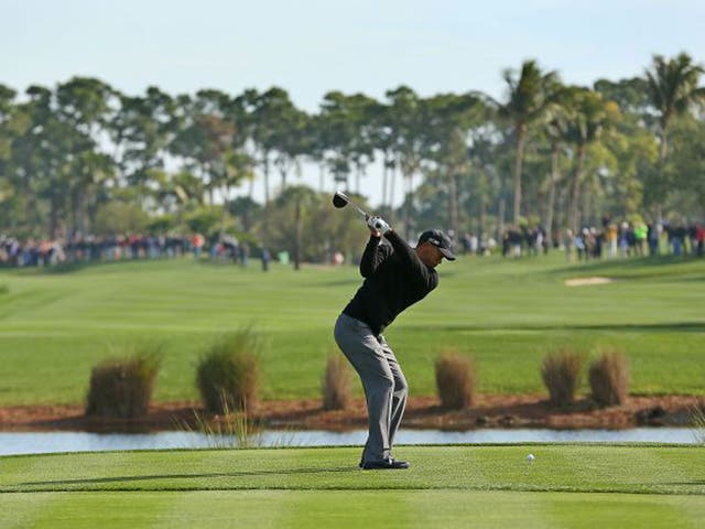 Tiger Woods tees off at the sixth hole of the Honda Classic course but was well off the pace