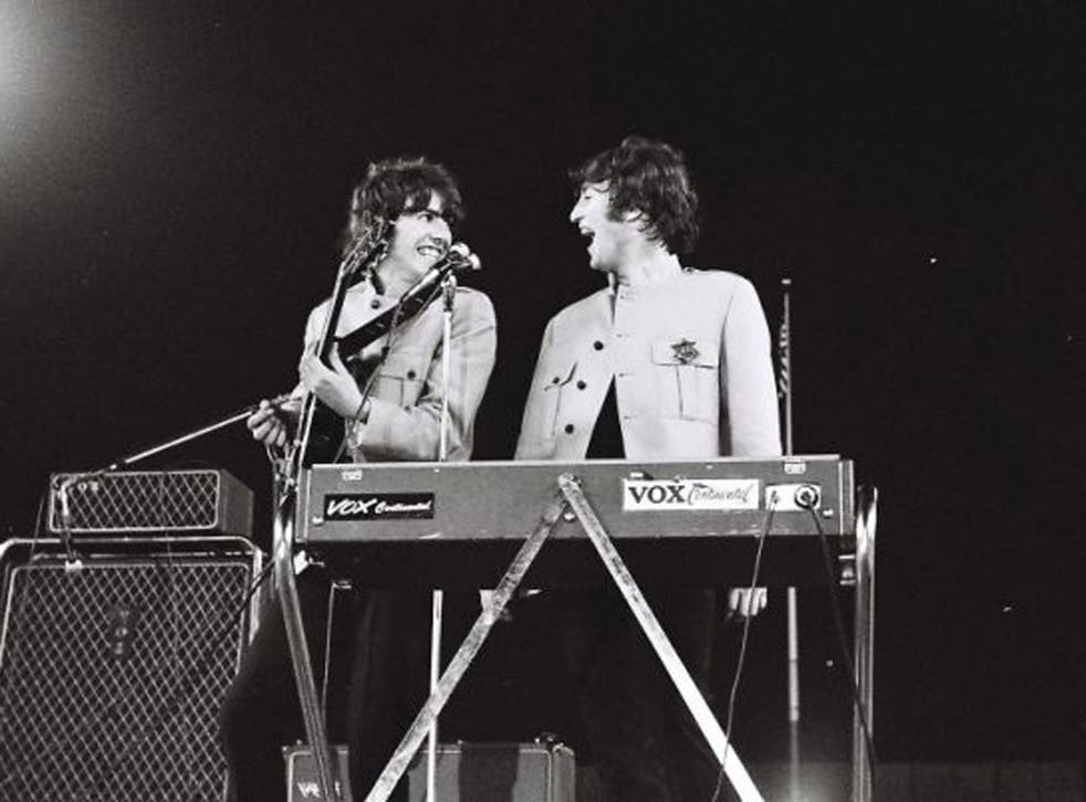 Handout photo issued by Omega Auctions of George Harrison (left) and John Lennon during The Beatles iconic Shea Stadium performance in August 1965 in New York