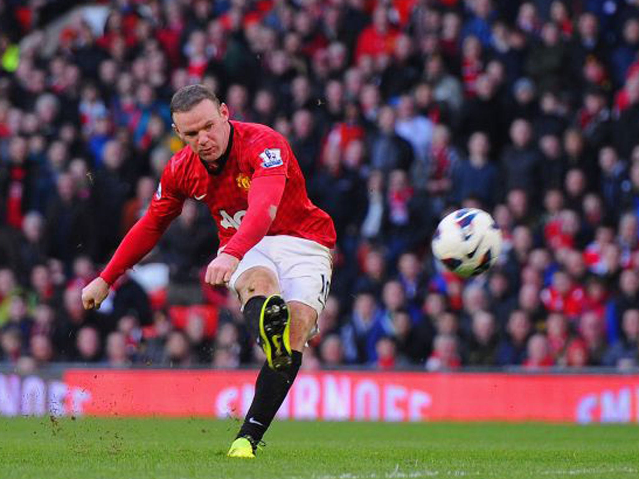 Wayne Rooney shoots to score United’s fourth goal against Norwich