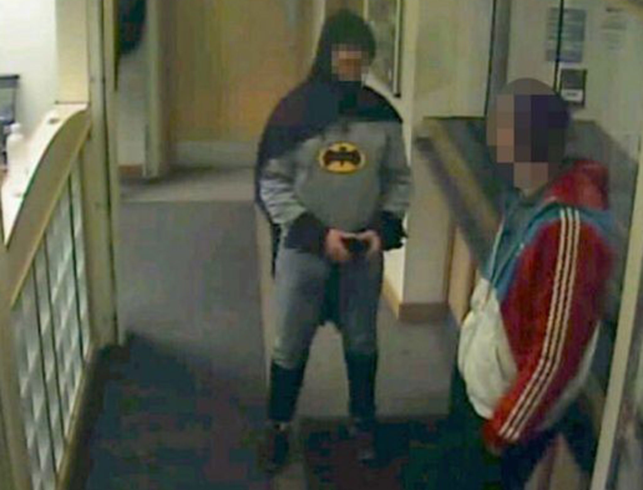 A man dressed as Batman marches a suspected fraudster to a police station in Bradford