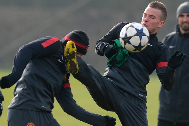 Wayne Rooney and Tom Cleverley clash during training