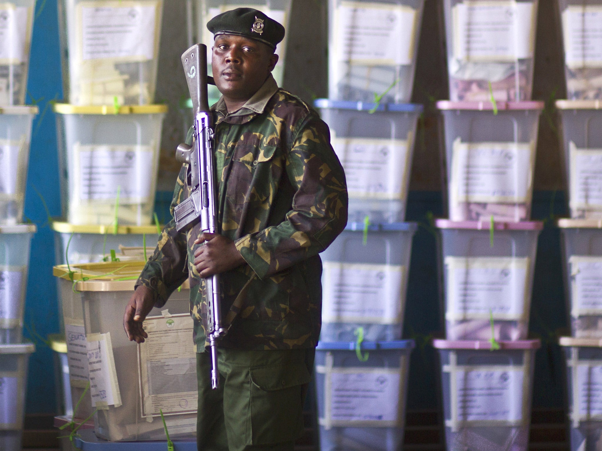 An officer of the prisons service guards ballot boxes in Nairobi