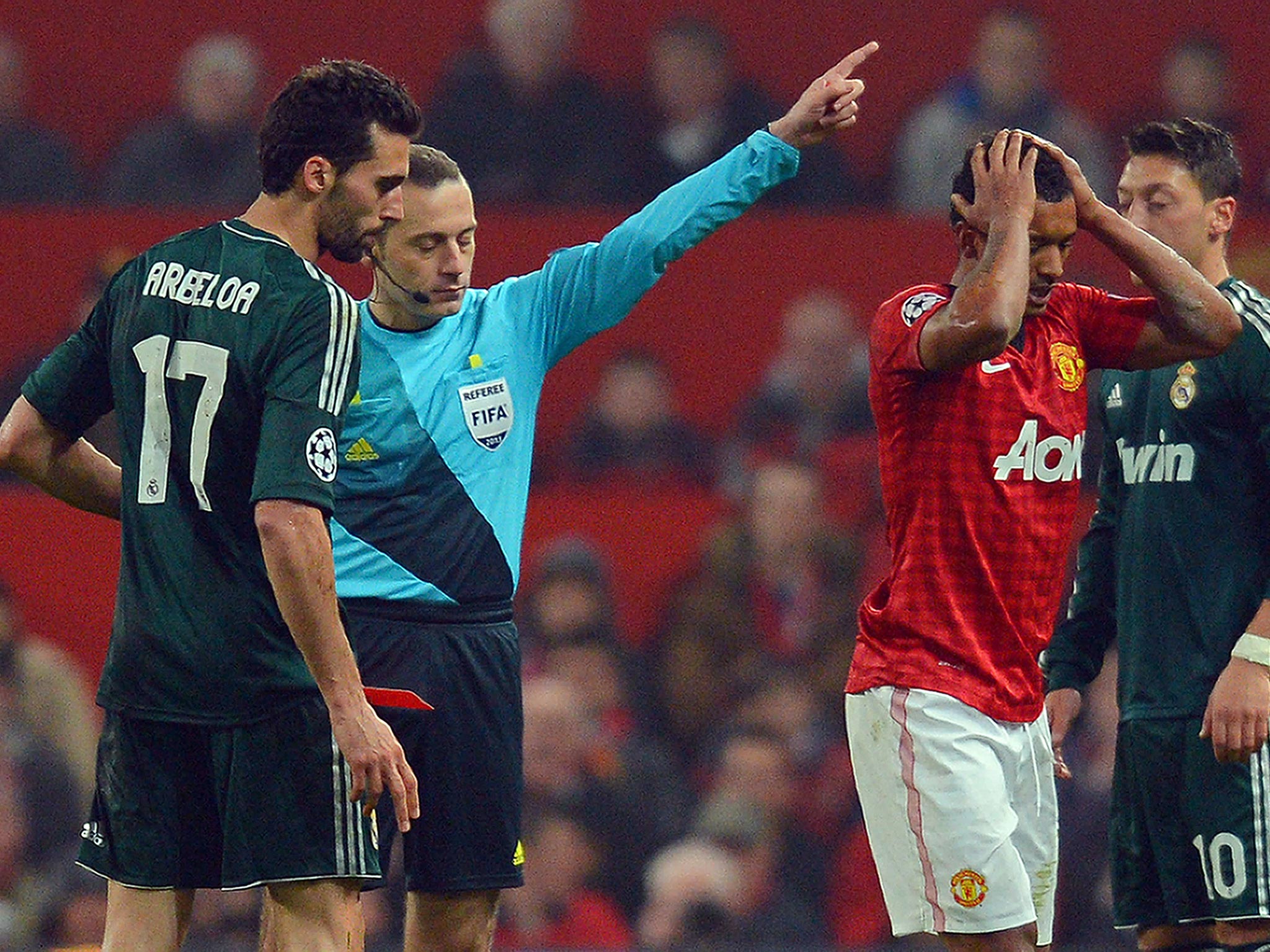 Cuneyt Cakir shows Nani a red card
